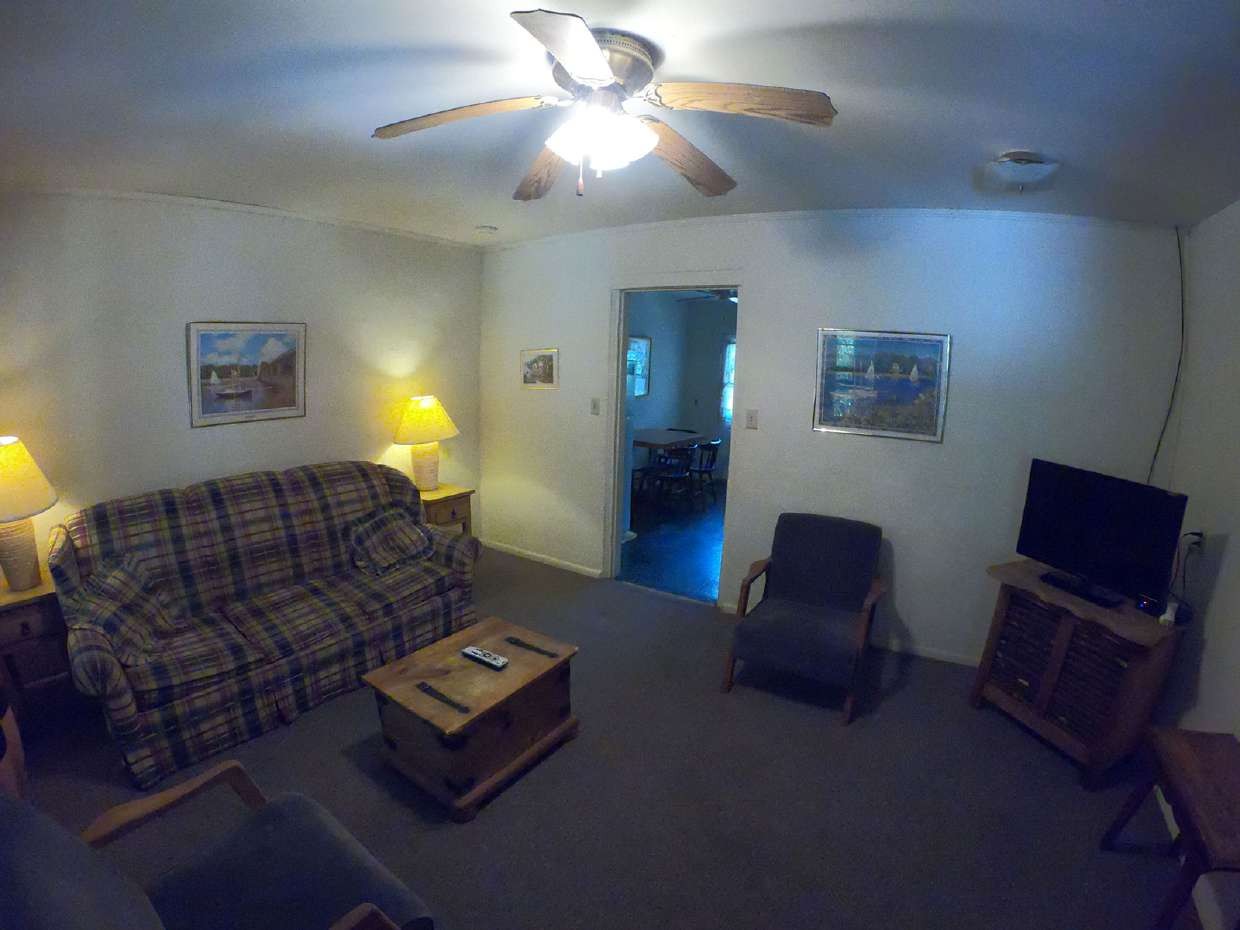 Suite living area with sofa, coffee table and TV