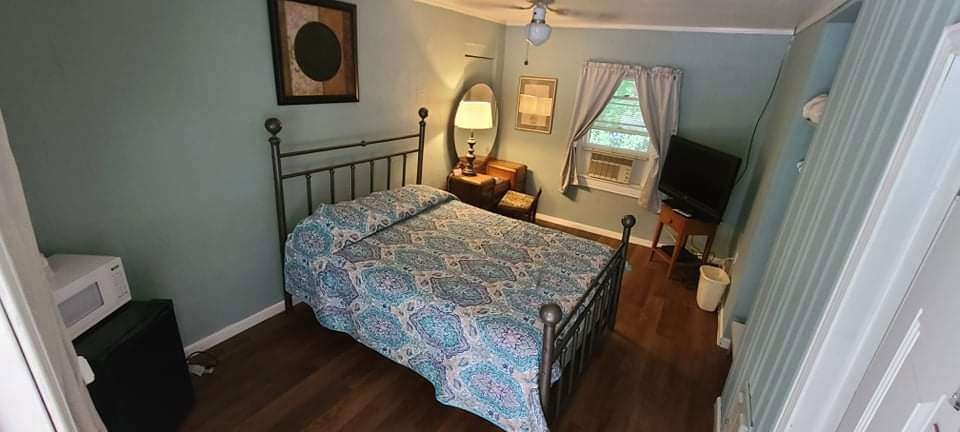 Light blue guest room with quilt bedspread