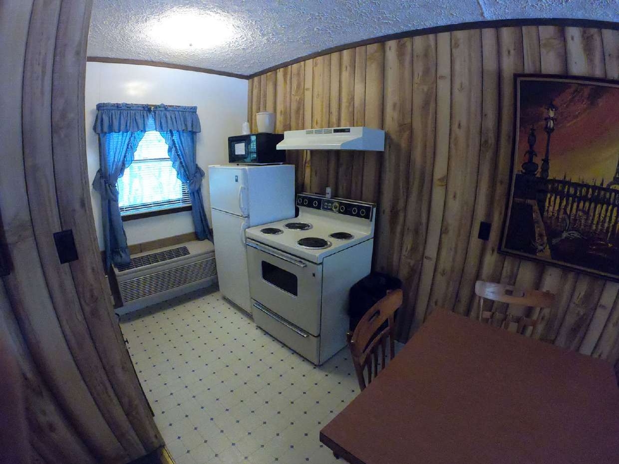 Kitchenette with compact stove, fridge and table