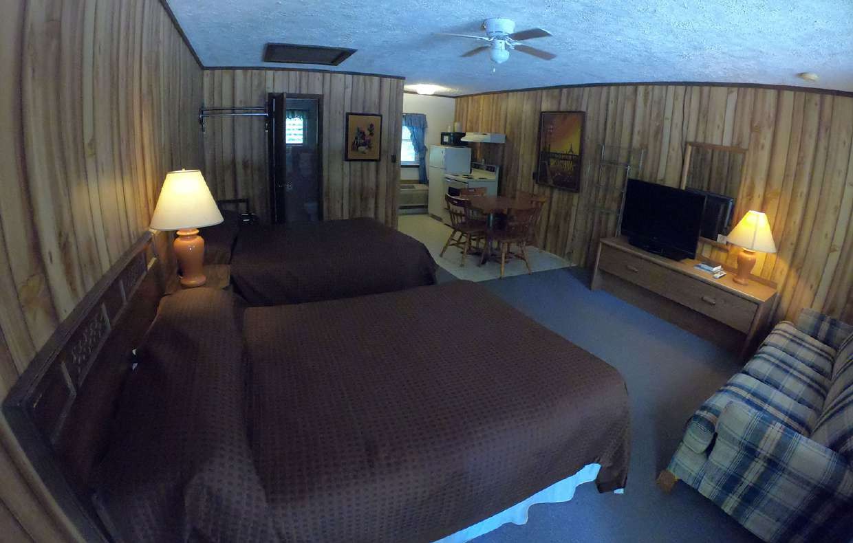 Rustic double-queen room with plaid blankets