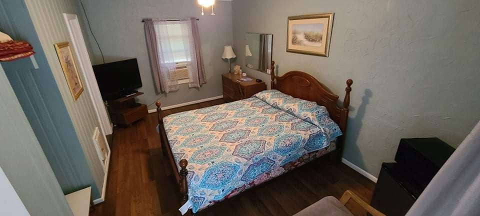 Bright motel room with quilt bedspread
