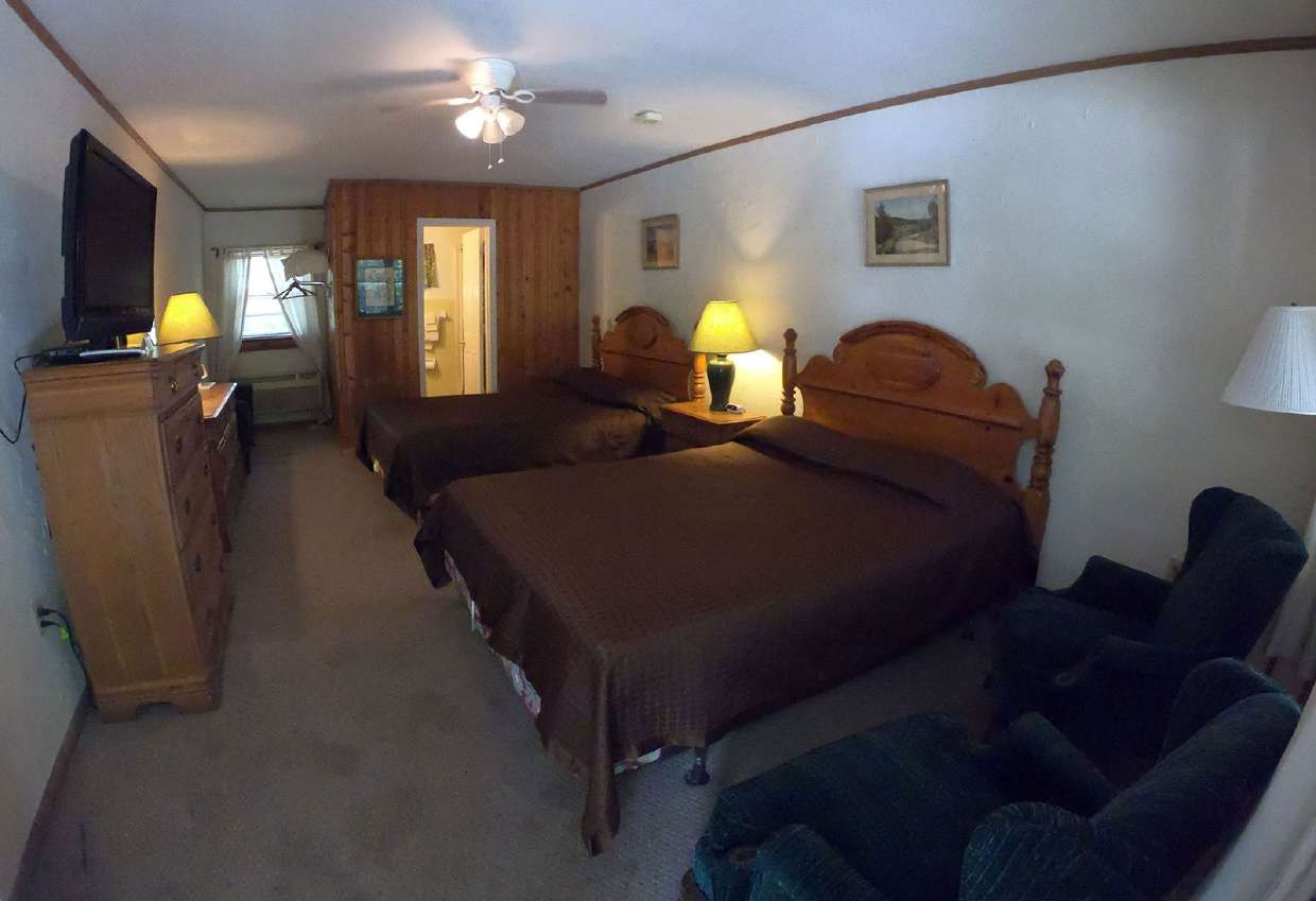 Two beds with warm bedside lamps