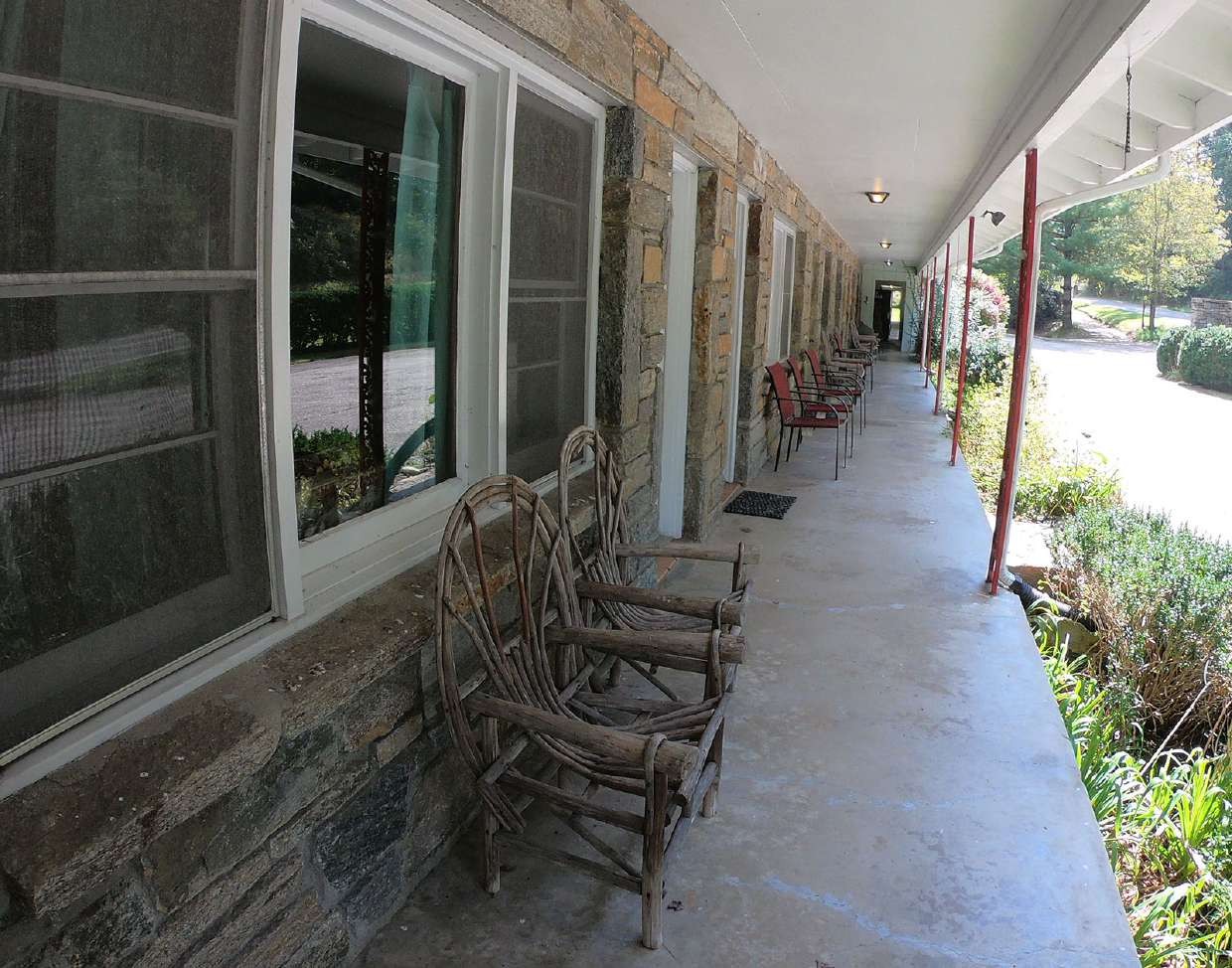 Covered porch lined with rocking chairs