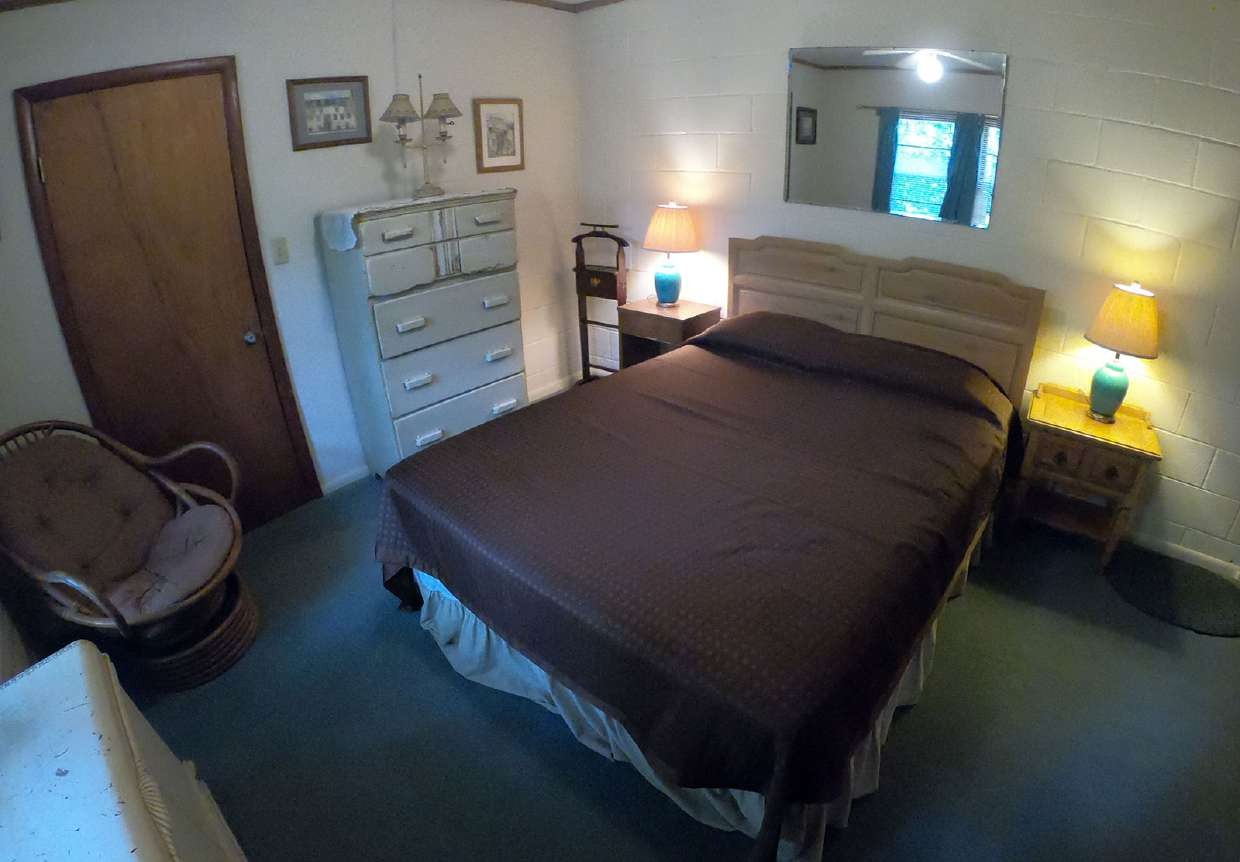 Wood-paneled room with wardrobe and single bed
